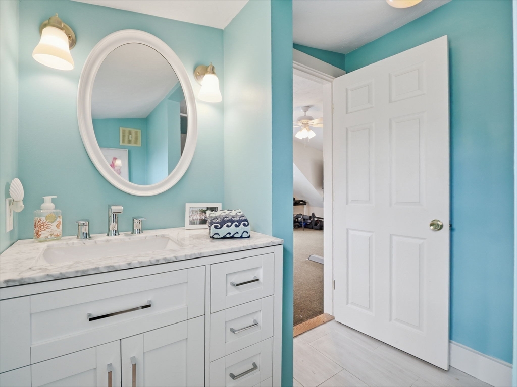 49 Salem Street Andover, MA 01810 - Photo 34 of 39 a bathroom with a granite countertop sink a mirror and a vanity