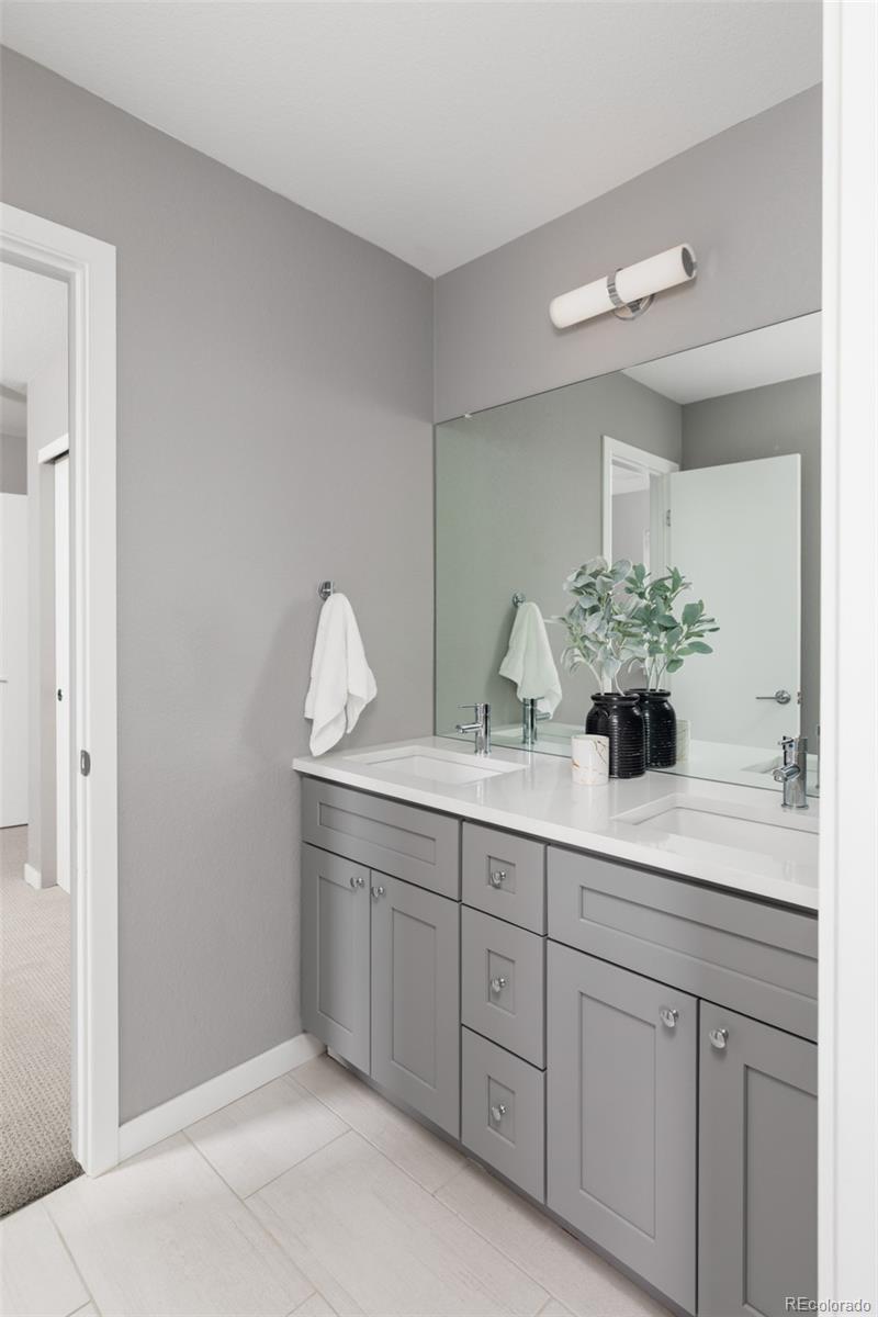 5230 Stuart Street Denver, CO 80212 - Photo 23 of 34 a bathroom with a sink and mirror