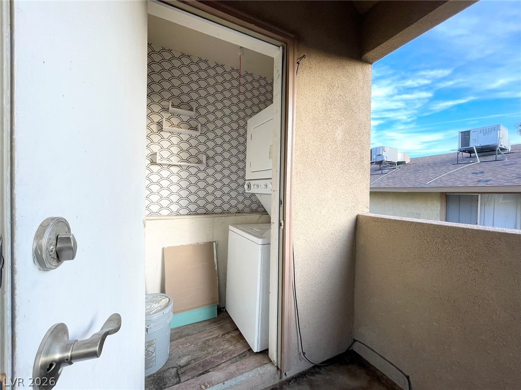 1834 North Decatur Boulevard, Unit 204 Las Vegas, NV 89108 - Photo 9 of 17 A convenient laundry area features stacked appliances, offering practical utility.