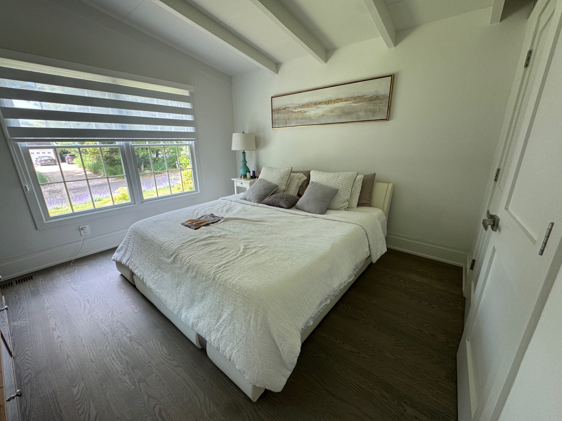 16 Fern Road Southampton, NY 11968 - Photo 5 of 9 a large bed sitting in a bedroom next to a window