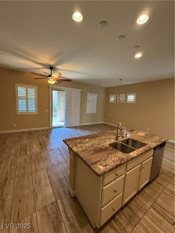 81 Einstein Ridge Way Las Vegas, NV 89183 - Photo 9 of 10 Kitchen with open floor plan, light stone counters, a center island with sink, recessed lighting, and healthy amount of natural light
