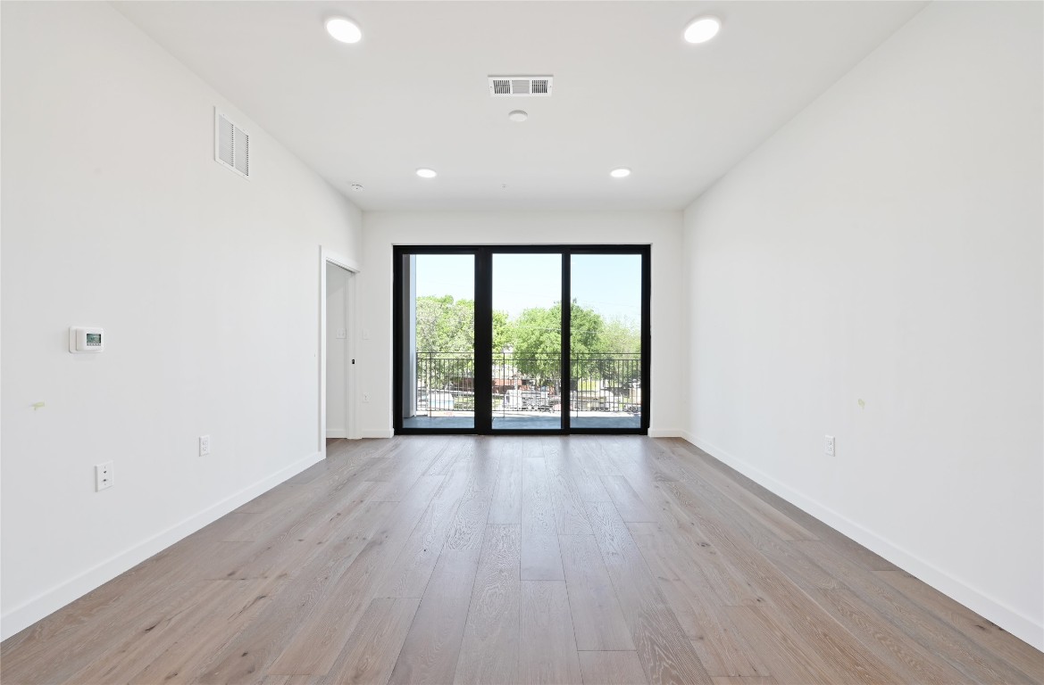 2209 South 1st Street, Unit 217 Austin, TX 78704 - Photo 2 of 29 wooden floor in an empty room with a window