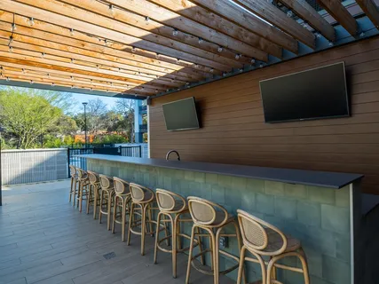 a view of a patio with couches chairs and wooden fence