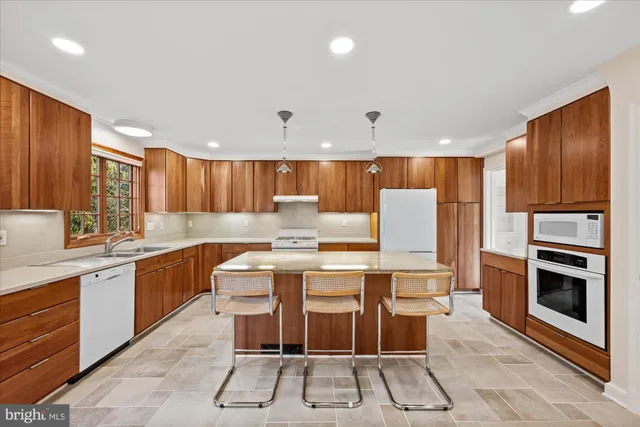 a kitchen with a sink a counter top space stainless steel appliances and cabinets