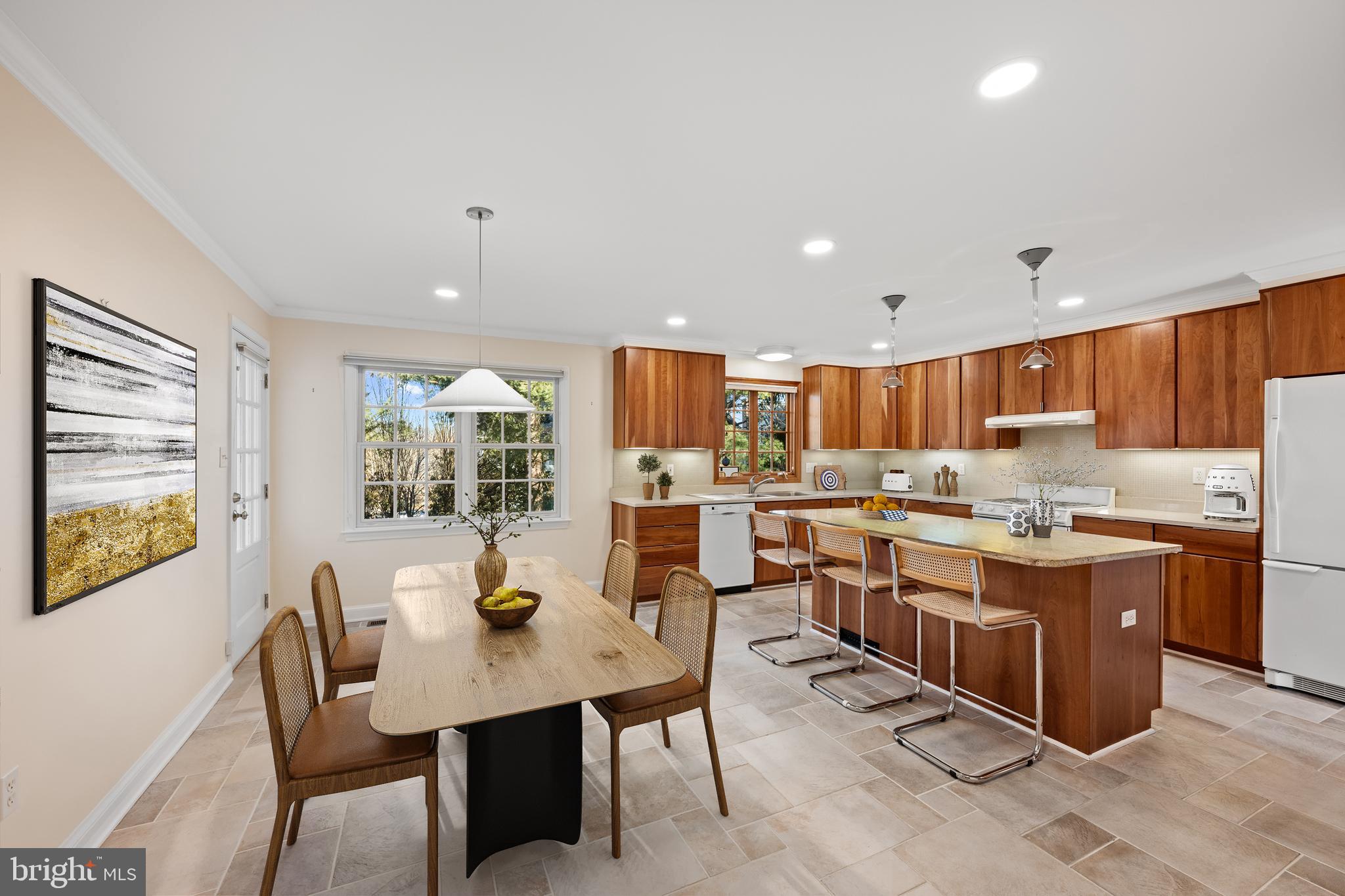 4238 50th Street Northwest Washington, DC 20016 - Photo 15 of 55 a open dining room with stainless steel appliances kitchen island granite countertop a table chairs and a refrigerator