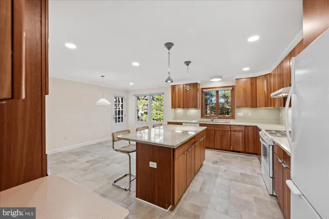 a kitchen with stainless steel appliances granite countertop a stove a sink dishwasher a refrigerator and a oven with wooden floor