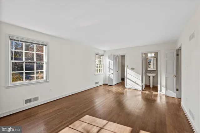 wooden floor in an empty room with a window