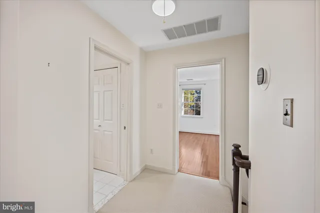 a view of a room with wooden floor and white walls