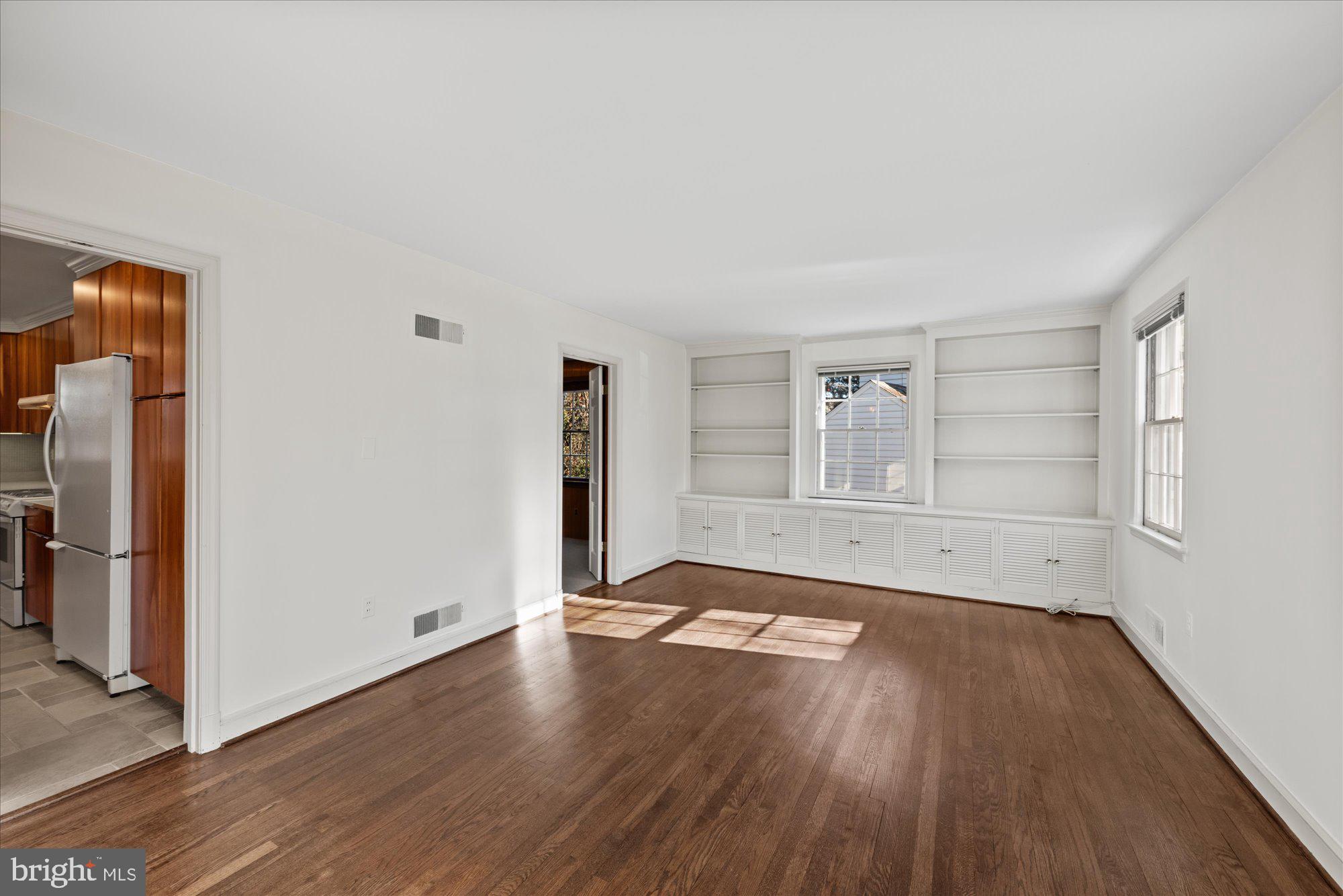 4238 50th Street Northwest Washington, DC 20016 - Photo 24 of 55 an empty room with wooden floor and windows