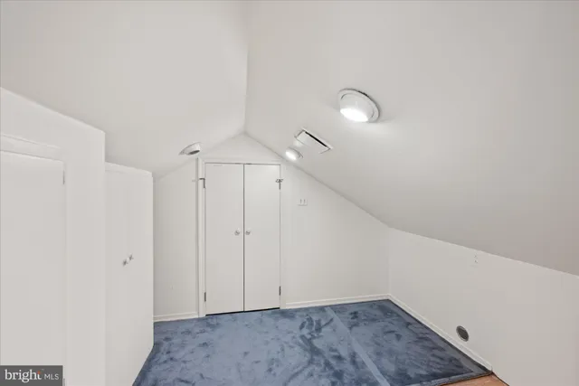 a bathroom with a granite countertop double vanity sink a mirror and a bathtub