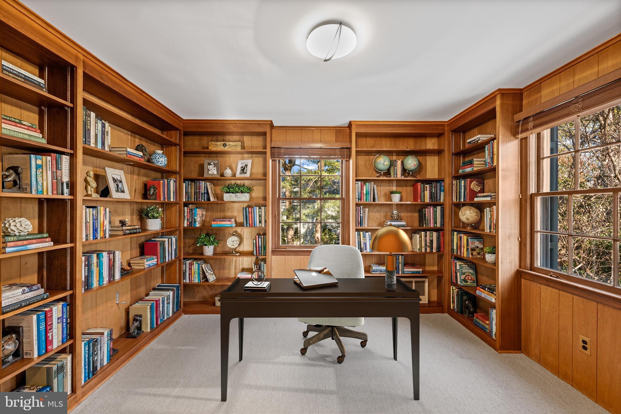 4238 50th Street Northwest Washington, DC 20016 - Photo 26 of 55 a view of a workspace with furniture and a bookshelf