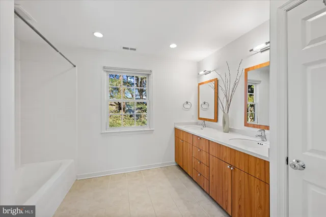 a bathroom with a double vanity sink and a mirror