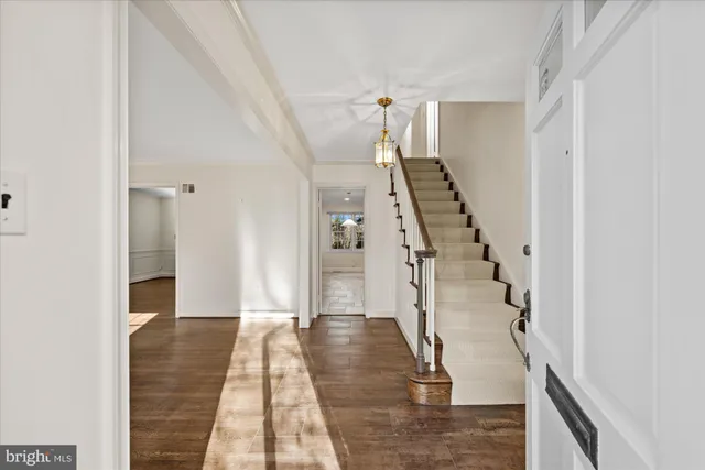 a view of entryway and hall with wooden floor