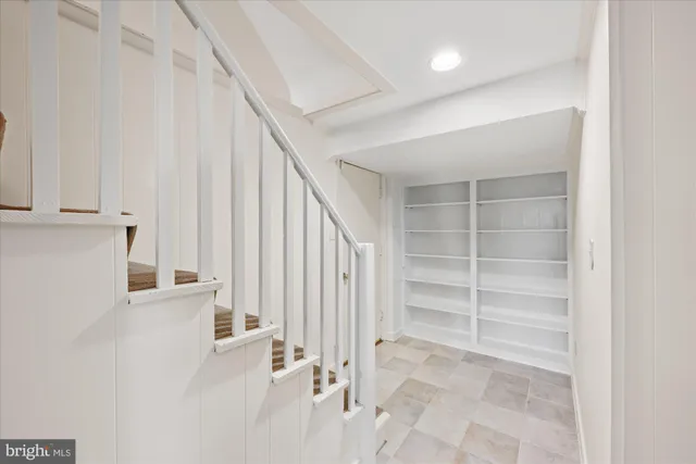 an empty room with large windows