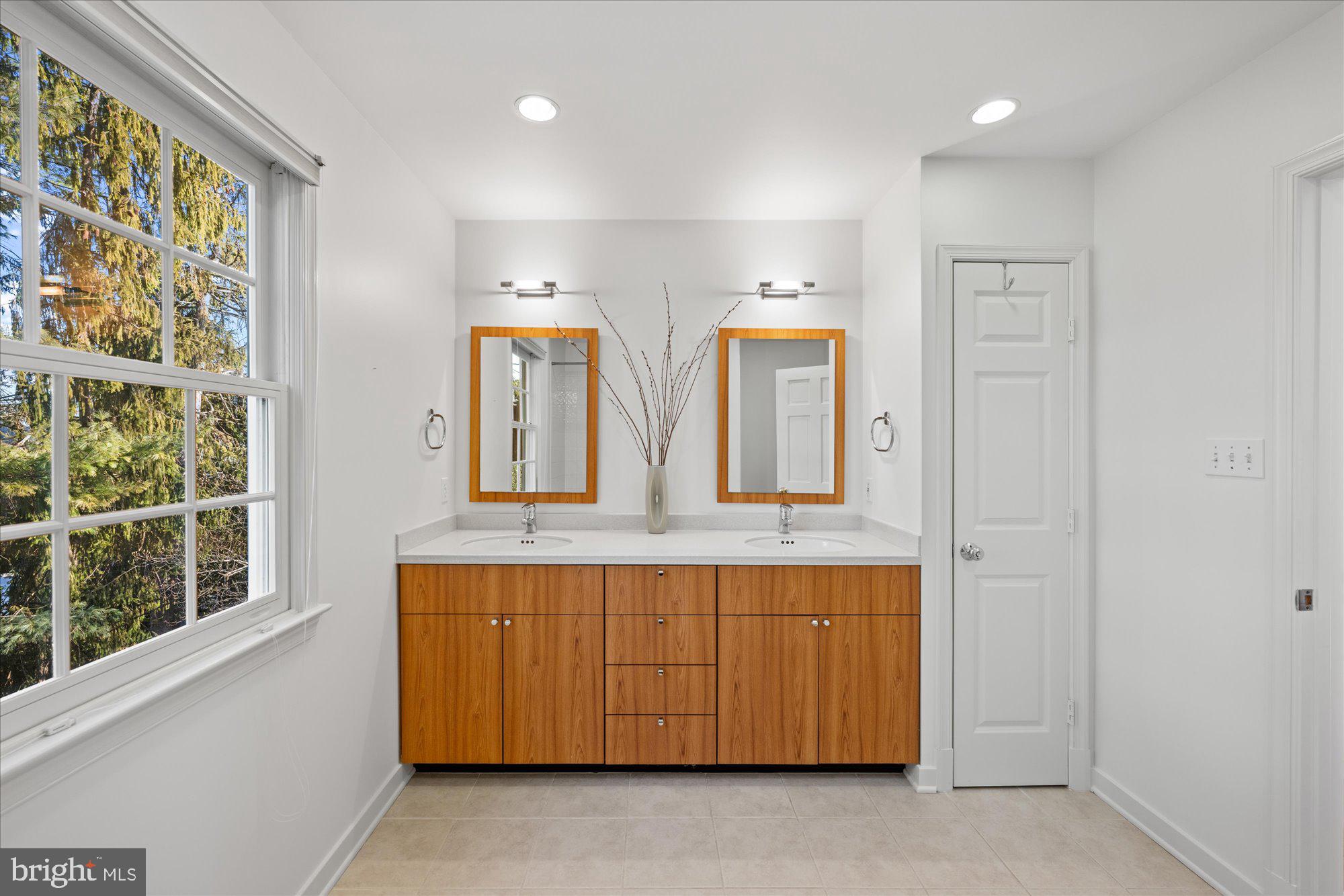 4238 50th Street Northwest Washington, DC 20016 - Photo 36 of 55 a bathroom with a double vanity sink and a mirror