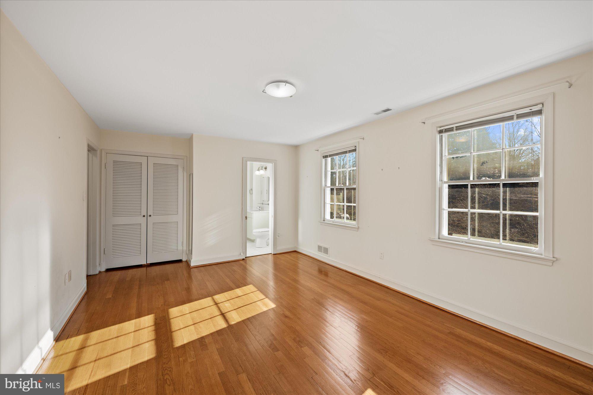 4238 50th Street Northwest Washington, DC 20016 - Photo 38 of 55 a view of an empty room with wooden floor and windows