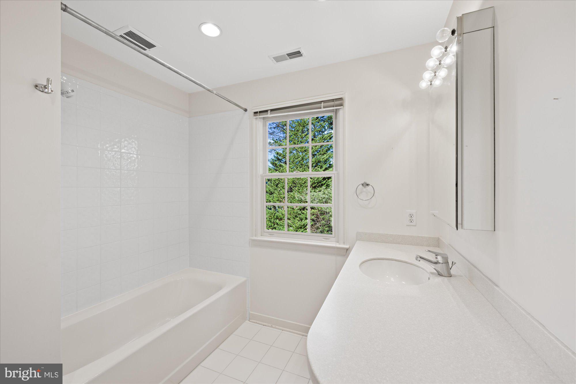 4238 50th Street Northwest Washington, DC 20016 - Photo 41 of 55 a bathroom with a bathtub and a shower