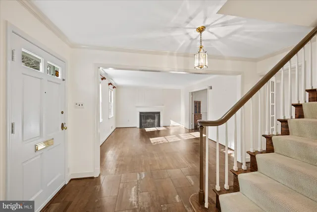 a view of entryway and hall with wooden floor