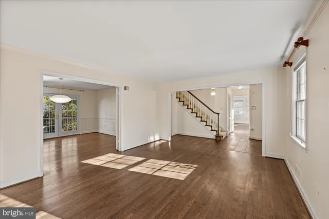 wooden floor in an empty room with a window