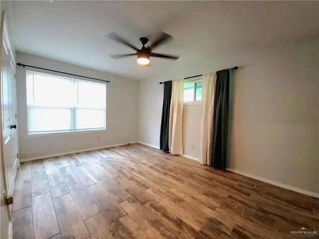 wooden floor in an empty room with a window