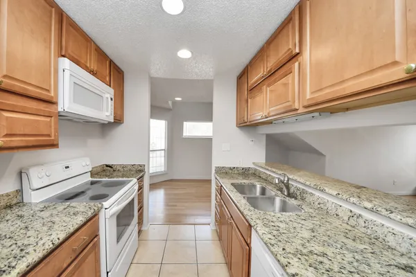 a kitchen that has a sink and a stove