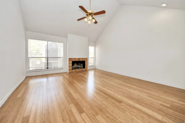 wooden floor in an empty room with a window