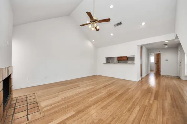 a view of a livingroom with a ceiling fan and wooden floor