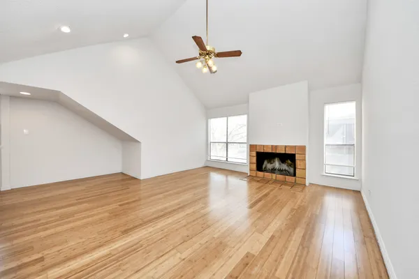 wooden floor in an empty room with a fireplace