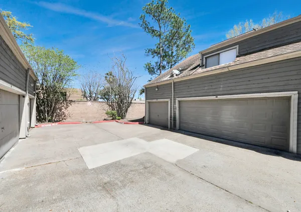 a side view of a house with a yard and garage