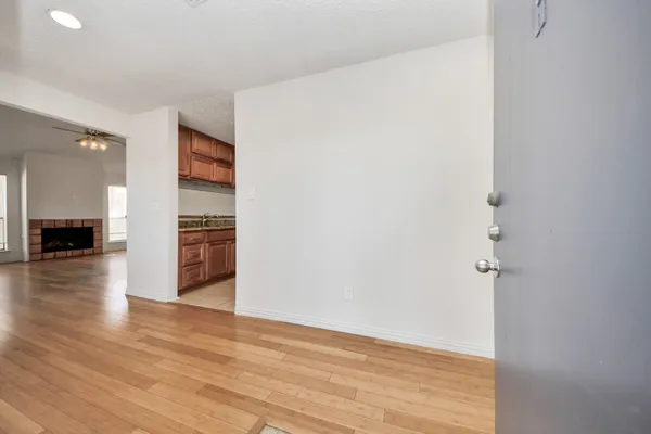 a view of empty room with wooden floor