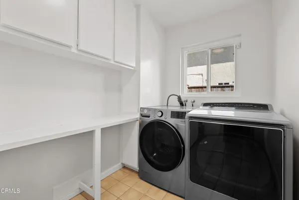 a utility room with sink dryer and washer