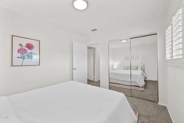 a large white bed in a white room