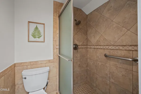 a bathroom with a toilet and a shower