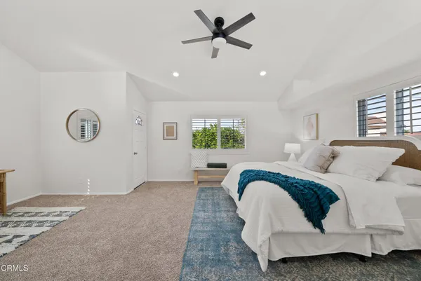 a living room with a bed furniture and a window