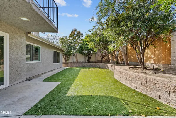 an aerial view of a house with a yard and potted plants