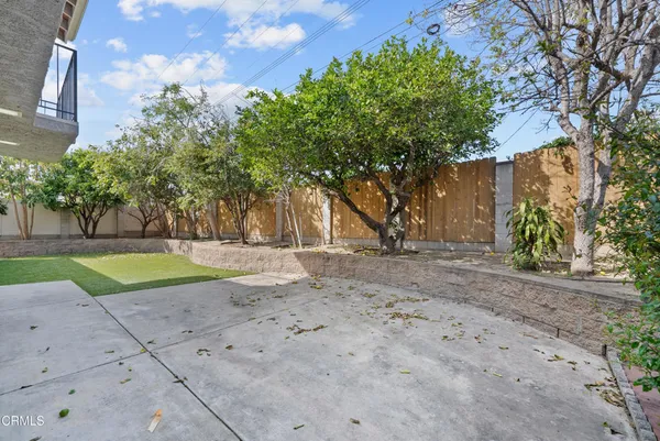 an aerial view of a house with a yard and large tree