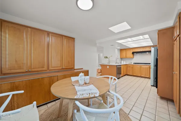 a dining room with furniture and a window