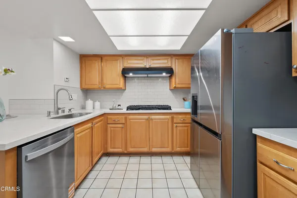 a kitchen with stainless steel appliances granite countertop a refrigerator and a sink
