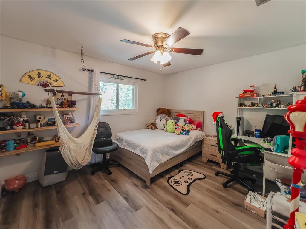 1810 Anchor Avenue DeLand, FL 32720 - Photo 15 of 29 a bedroom with furniture and a wooden floor