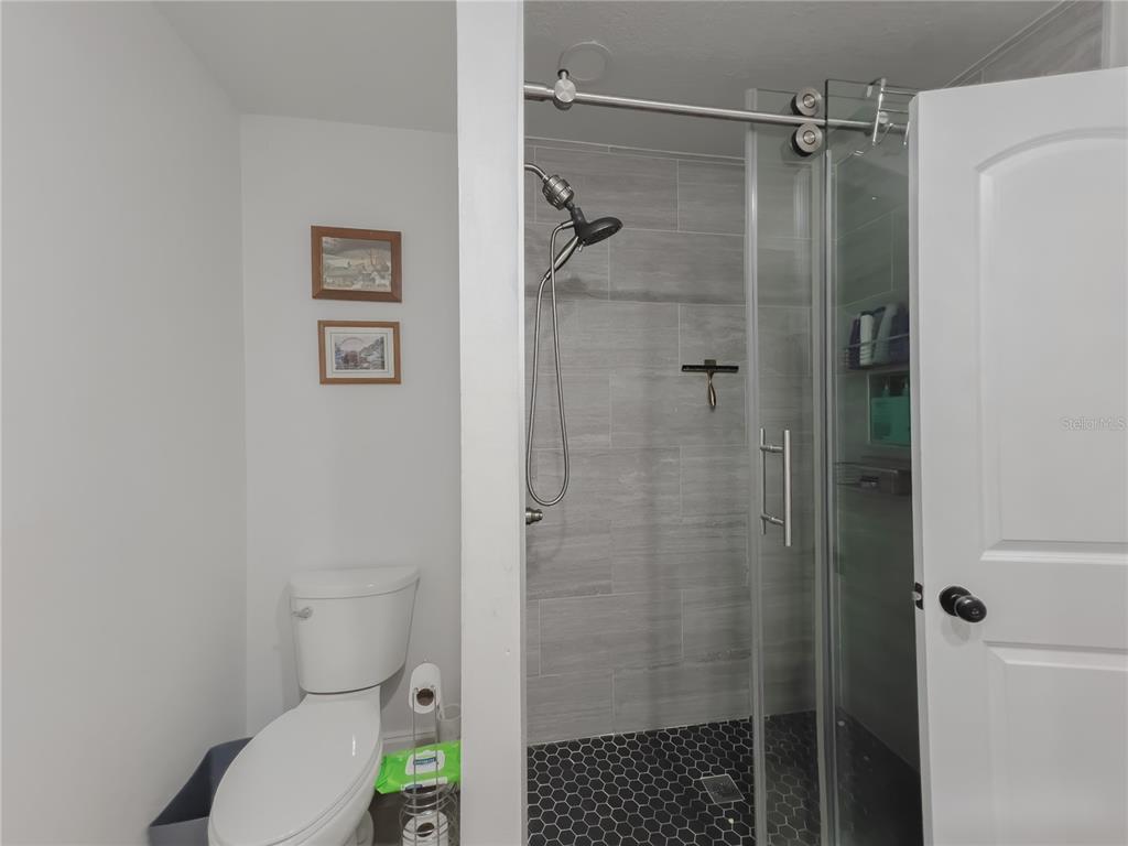 1810 Anchor Avenue DeLand, FL 32720 - Photo 17 of 29 a bathroom with a toilet and a shower
