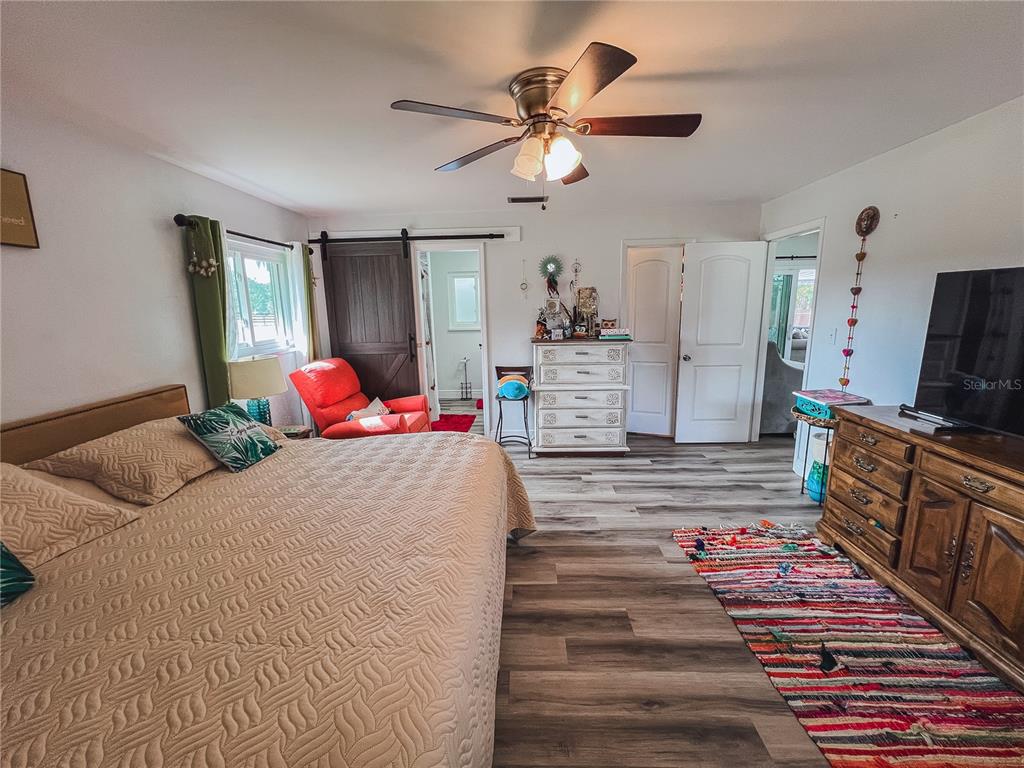 1810 Anchor Avenue DeLand, FL 32720 - Photo 19 of 29 a bedroom with a bed and wooden floor