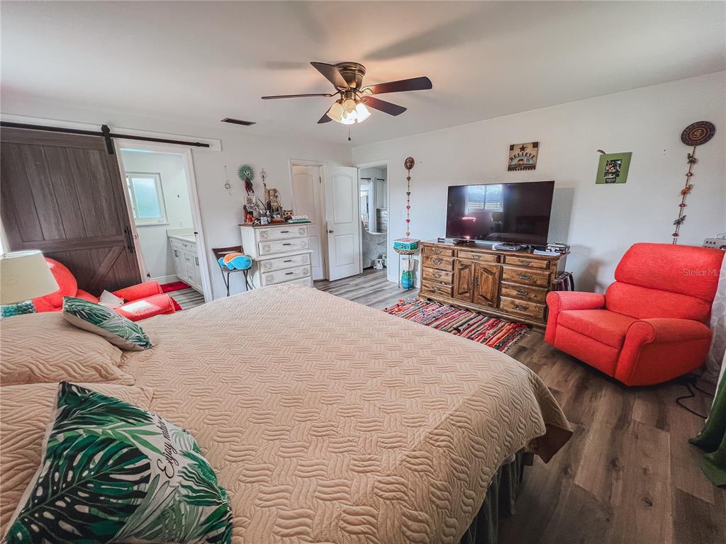 1810 Anchor Avenue DeLand, FL 32720 - Photo 20 of 29 a bedroom with a bed and a flat screen tv