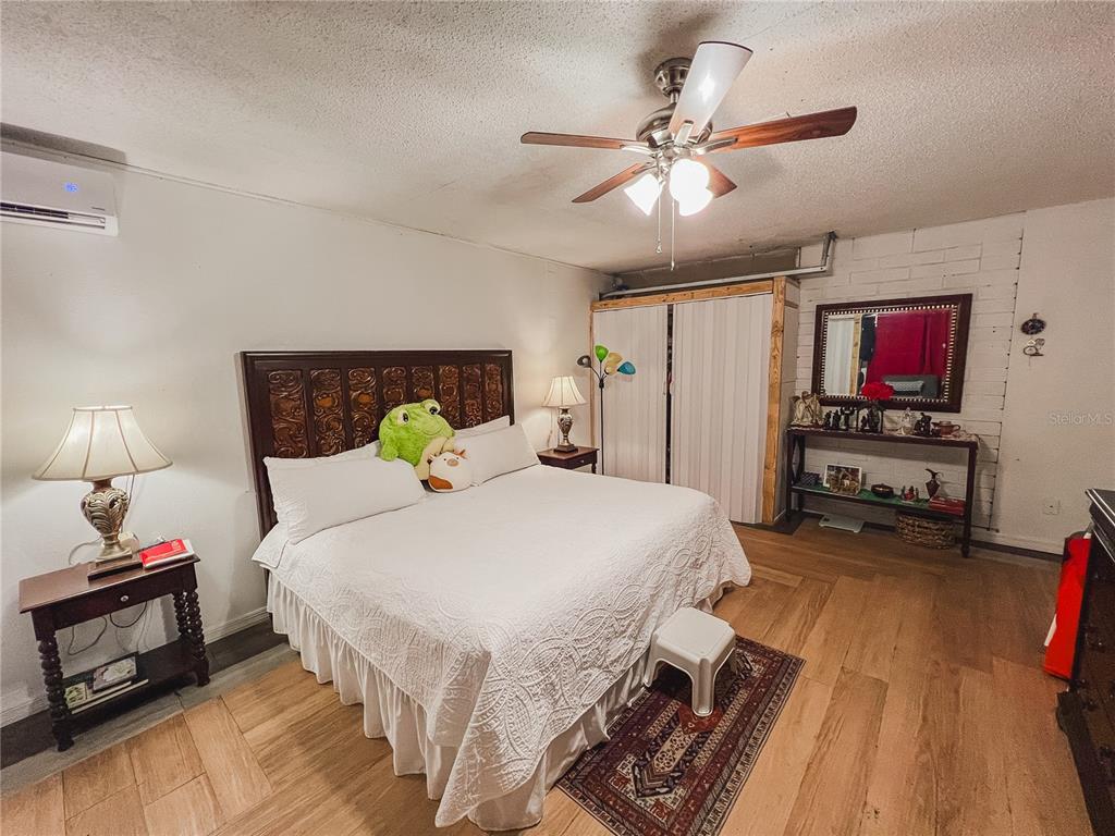1810 Anchor Avenue DeLand, FL 32720 - Photo 22 of 29 a spacious bedroom with a bed and a flat tv screen on dresser