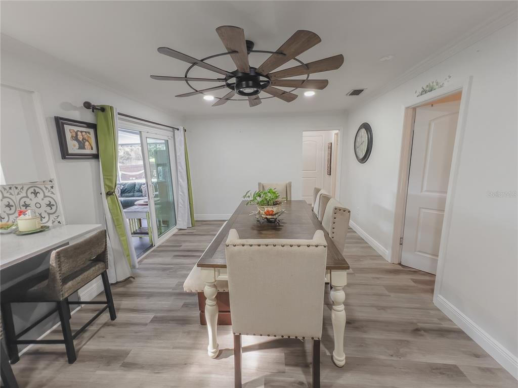 1810 Anchor Avenue DeLand, FL 32720 - Photo 5 of 29 a view of a dining room with furniture and wooden floor