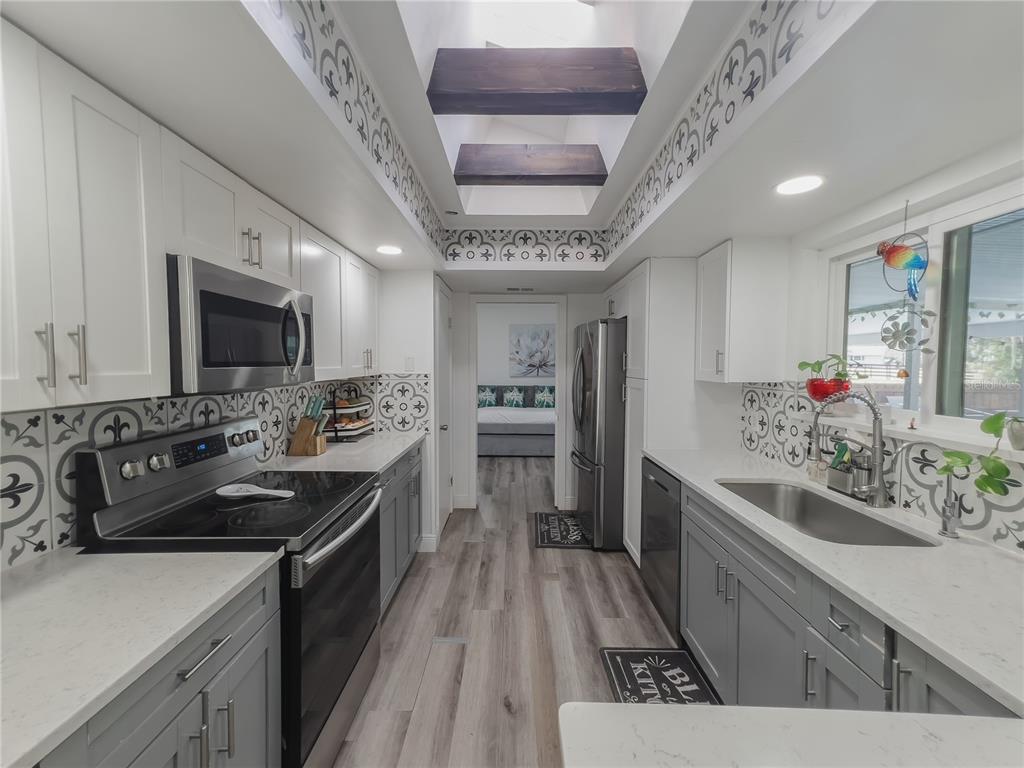 1810 Anchor Avenue DeLand, FL 32720 - Photo 6 of 29 a kitchen with stainless steel appliances granite countertop a sink stove and refrigerator