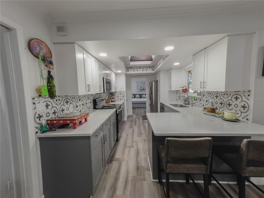 1810 Anchor Avenue DeLand, FL 32720 - Photo 8 of 29 a kitchen with stainless steel appliances kitchen island granite countertop a sink and cabinets
