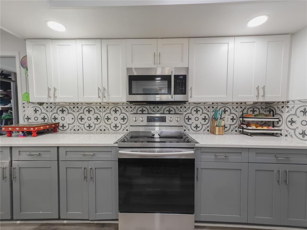 1810 Anchor Avenue DeLand, FL 32720 - Photo 10 of 29 a kitchen with granite countertop cabinets stainless steel appliances and sink