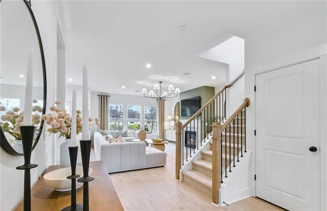 a living room with lots of furniture and a chandelier