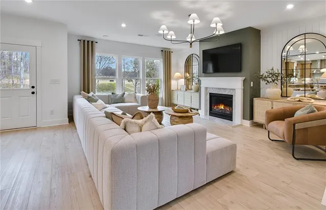 a living room with furniture fireplace and flat screen tv