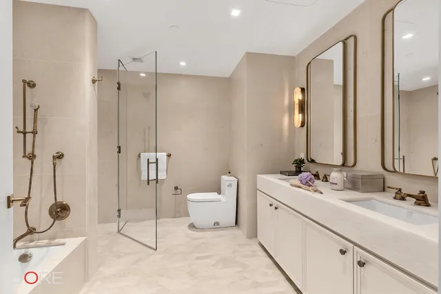 a bathroom with a double vanity sink mirror and toilet